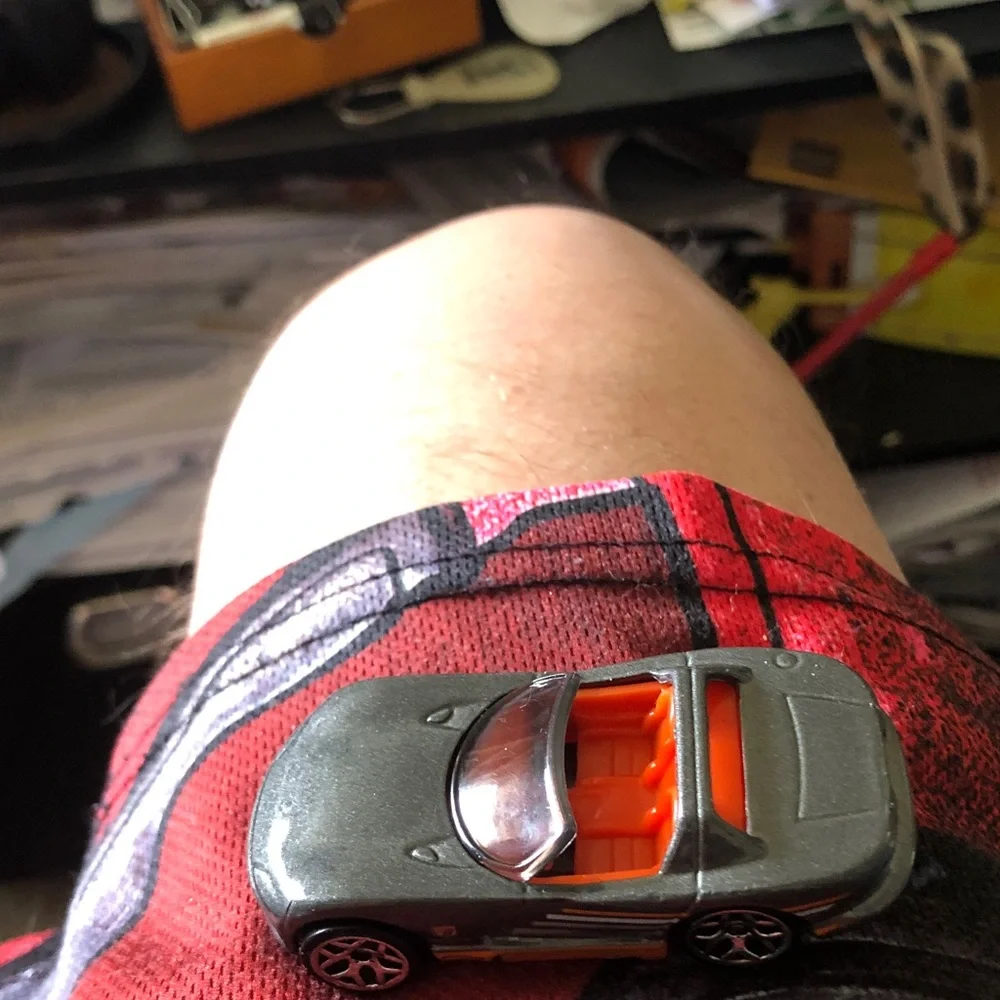 Small Gray Toy Car with Orange Interior